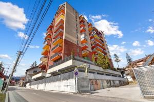 a tall building on the side of a street at Asteri Garden & Terrace Apartment in Sinaia