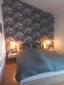 a bedroom with a large bed with a black wall at Apartment Villa Louise in Sankt Kanzian