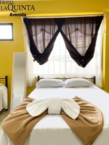 Ein Bett oder Betten in einem Zimmer der Unterkunft Hotel Quinta Avenida