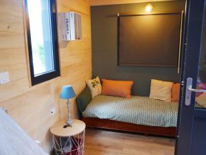 a small room with a bed and a lamp at Tiny house ocean in Naujac-sur-Mer