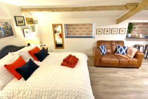 a bedroom with a large bed and a couch at The Little House in Cotherstone