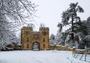 an old castle with snow on the ground at Zen Cottage Winchcombe Cheltenham in Cheltenham