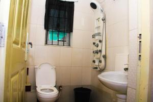 a small bathroom with a toilet and a sink at Unique 1BEDROOM Shortlet Stadium Rd with 24hrs light-FREE WIFI -N35,000 in Port Harcourt