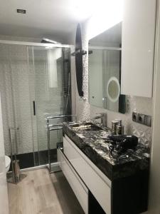 a bathroom with a sink and a shower at Sitges Oasis in Sitges +6 photos