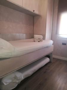 a bed with two towels sitting on top of it at Sitges Oasis in Sitges