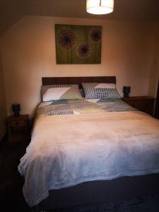 a bedroom with a large bed with two pillows at The Barn in Durham