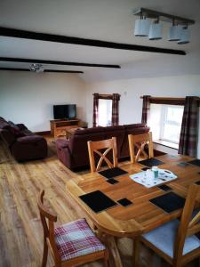 a living room with a wooden table and a couch at The Barn in Durham