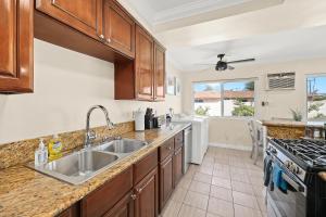 a kitchen with a sink and a stove at Sunny & Cheerful Near I-10 Queen Beds w Parking! in Alhambra
