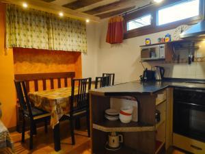 a kitchen with a table and a small table and a table and chairs at Plaza Consistorial in Pamplona