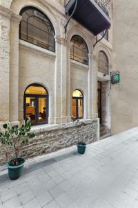 a building with two potted plants in front of it at Pera Rasso Hotel in Istanbul