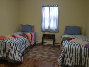 Ένα ή περισσότερα κρεβάτια σε δωμάτιο στο Stay Awhile