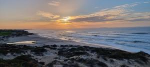an aerial view of a beach at sunset at Penthouse Casa Astona in Amoreira