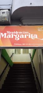 an escalator with a sign that readsrestructuringautsmitemite at Residencias MARGARITA in Manizales