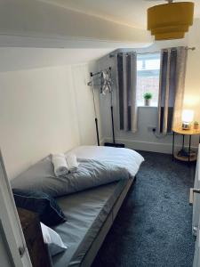 a bedroom with a bed with two towels on it at Railway House - By EazyStays in Crewe
