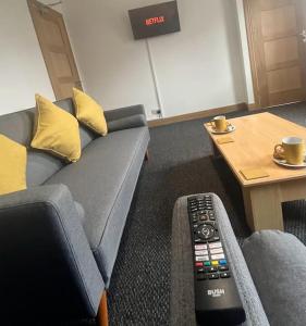 sala de estar con sofá y mando a distancia en Stylish 2 bed apartment., en Birmingham