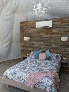 a bedroom with a bed with a wooden wall at Maple Park in Kilmore East