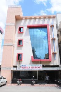 um edifício com uma placa na frente dele em Hotel Agarala Residency em Tirupati