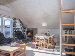 a living room with a table and chairs and a fireplace at Holiday home Harboøre XLII in Harboør
