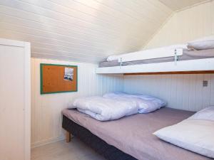 two beds in a room with two bunk beds at Holiday home Harboøre XLII in Harboør