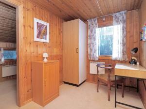 a room with wooden walls and a desk and a window at 5 person holiday home in Føllenslev-By Traum in Føllenslev