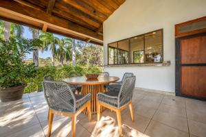 a dining room with a table and chairs on a patio at Casa Carmen in Potrero