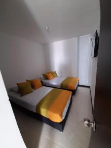 two beds in a small room with at Apartamentos para tus vacaciones in Armenia