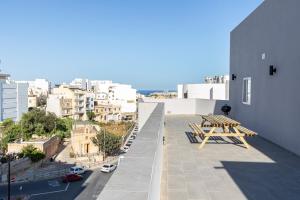 a view from the roof of a building with benches at H4- Modern Penthouse with Large Terrace and Views in San Ġwann