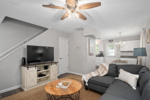 a living room with a couch and a flat screen tv at Beach Twin B KDH123B in Kill Devil Hills