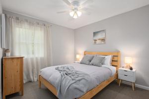 a bedroom with a bed and two lamps and a window at Beach Twin B KDH123B in Kill Devil Hills
