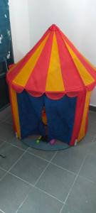a red yellow and blue play tent on the floor at Kerian Putra Muslimstay in Parit Buntar