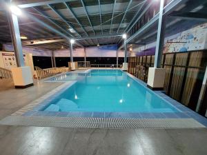 a large swimming pool in a large building at Residenciale Boutique Apartments in Manila