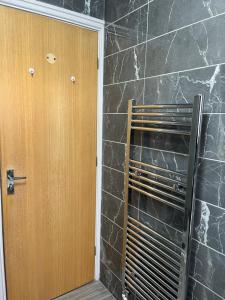 a bathroom with a door and a stone wall at Entire house with parking in Manchester