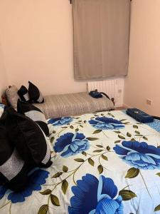 a bedroom with a bed with blue flowers on it at 004- Brand new 1 bedroom apartment F1 in Ealing