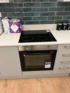 a kitchen with a stove top oven in a counter at 004- Brand new 1 bedroom apartment F1 in Ealing