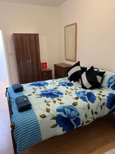 a bedroom with a bed with blue flowers on it at 004- Brand new 1 bedroom apartment F1 in Ealing