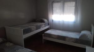 a bedroom with two bunk beds and a window at Casa Lo de Juan in Santa Rosa