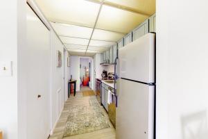 a kitchen with a refrigerator and a hallway at Decatur House 501 in Ocean City