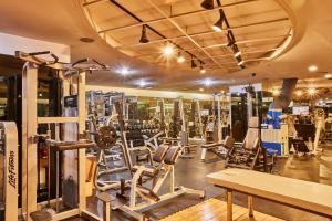 a gym with several treadmills and weights at Provista Hotel in Seoul