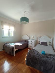 a bedroom with two beds and a baby laying on the floor at Casa da Avó do Puto in Mealhada +37 photos