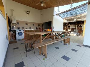 a kitchen with a wooden table and a washing machine at Casa da Avó do Puto in Mealhada