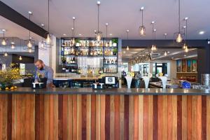 バサーストにあるThe George Hotel Bathurstのレストランのバーに立つ男