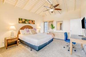 a bedroom with a bed and a desk and a computer at Poipu Sands 221 in Koloa