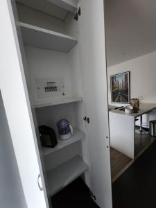 a small room with white shelves and a desk at Hermoso Apto moderno Cota in Cota