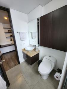 a bathroom with a white toilet and a sink at Hermoso Apto moderno Cota in Cota