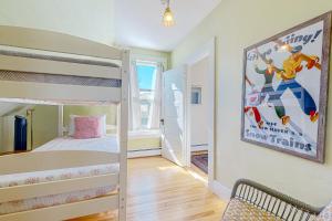 a bedroom with two bunk beds and a poster on the wall at A Villager's Dream in North Conway