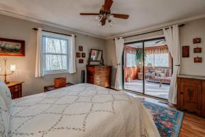 a bedroom with a bed and a sliding glass door at The Bird House in Dillard
