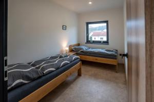 Postel nebo postele na pokoji v ubytování Lázeňské Apartmány