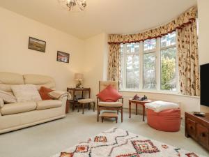 a living room with a couch and a table at Clover Leaf in Guisborough