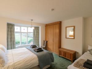 a bedroom with two beds and a window at Clover Leaf in Guisborough
