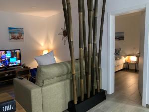 een woonkamer met een bank en een tv bij Cristal House 250 meters from Monte Gordo beach in Monte Gordo